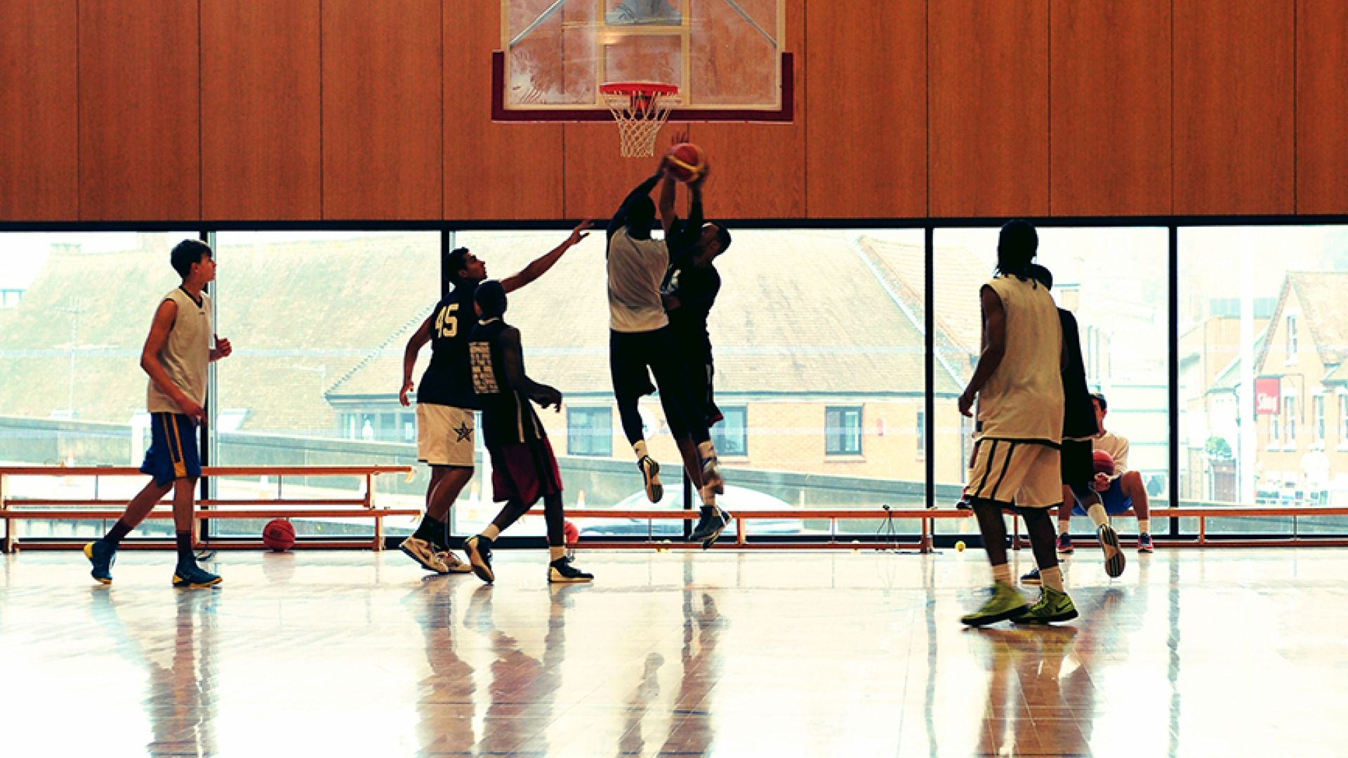 Men playing basketball in the sports hall