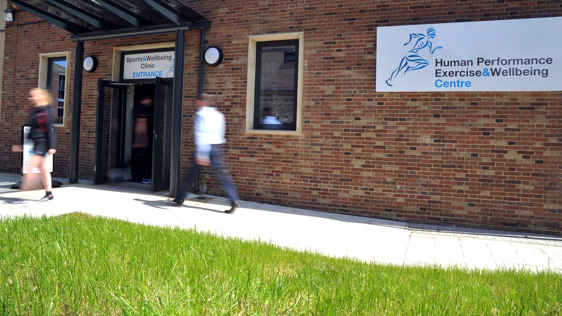 A photo of the Human Performance, Exercise and Wellbeing Centre sign on the outside of the building