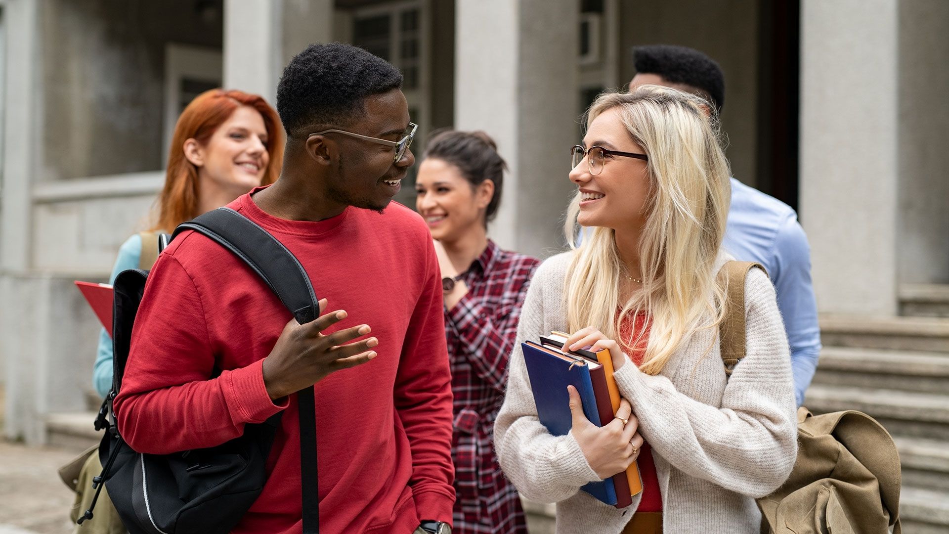 Two students standing next to each other talking