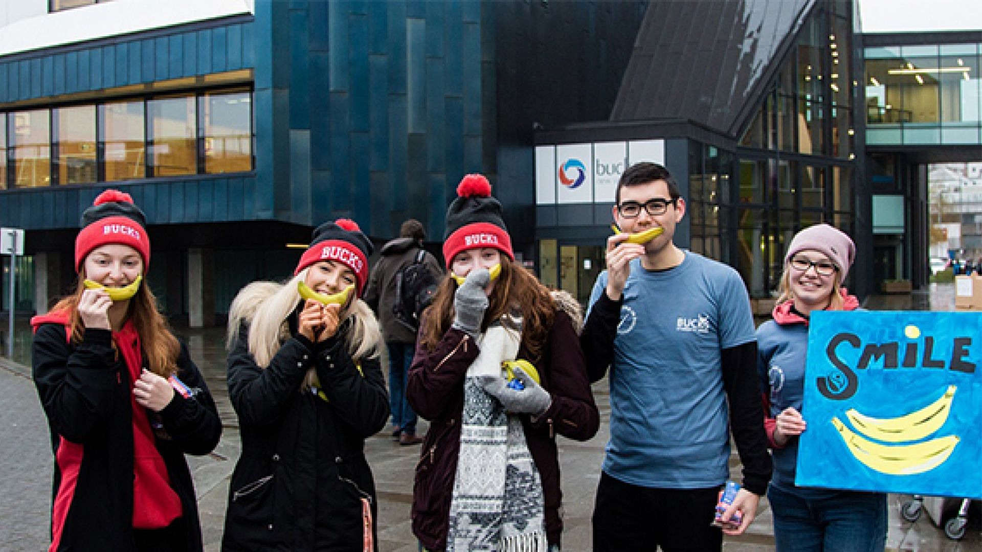 Five students stood outside the gateway building