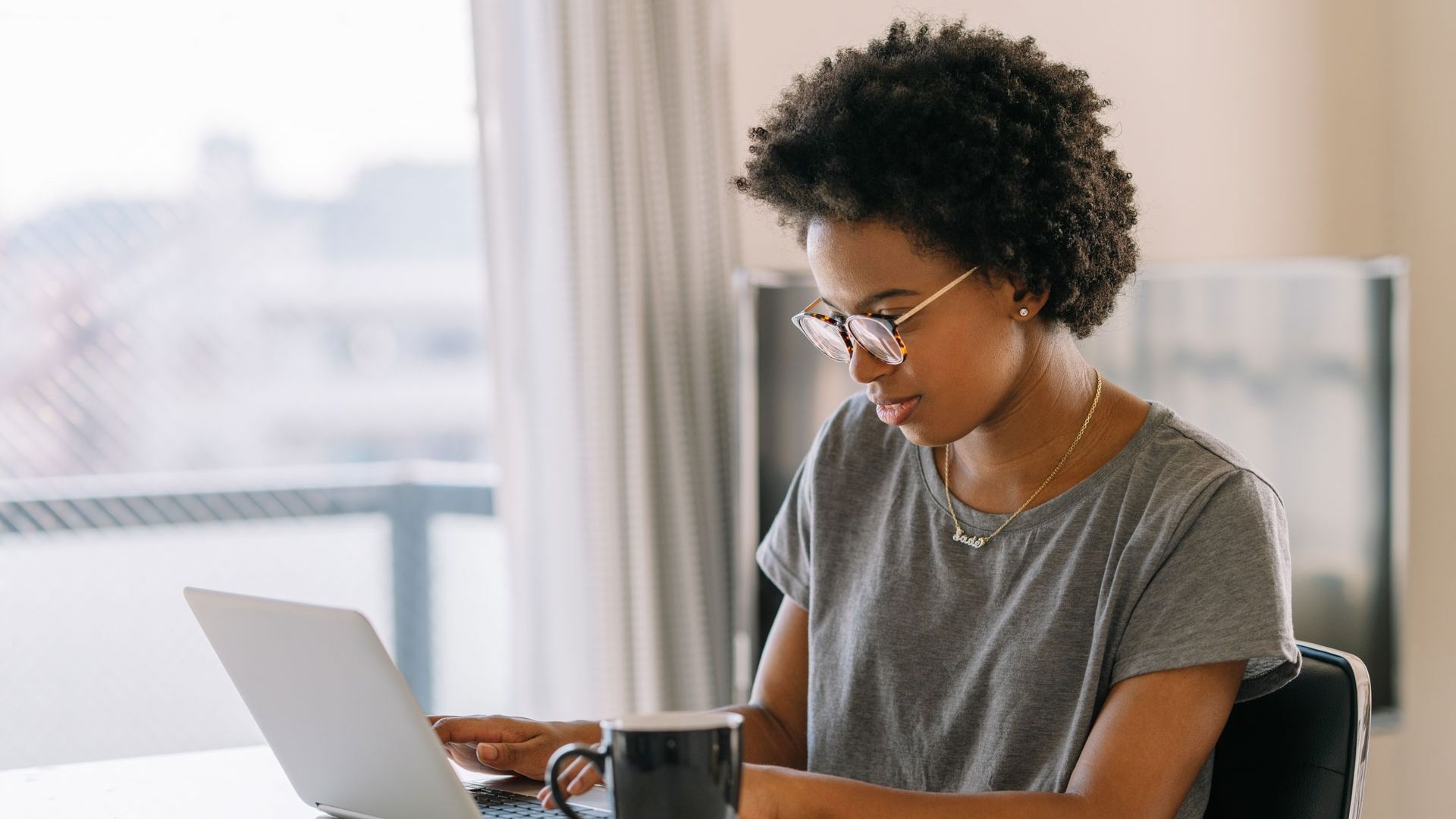 Young female student on a laptop at desk