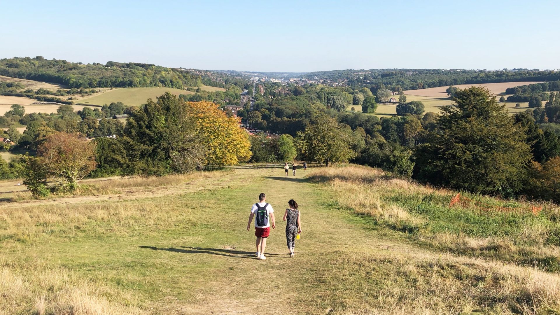 Male and female student walking in the English countryside