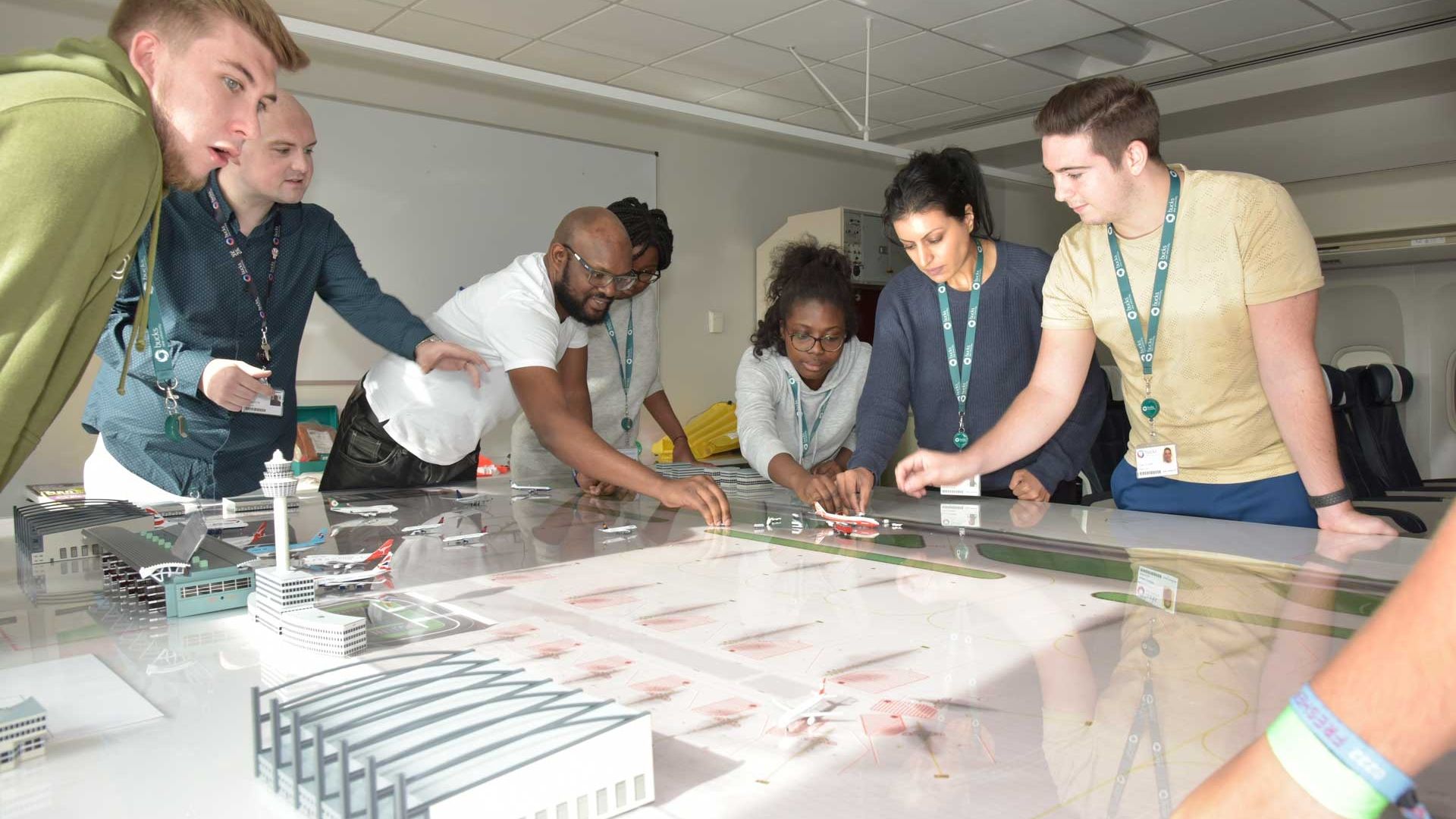 Seven students gathered around a table