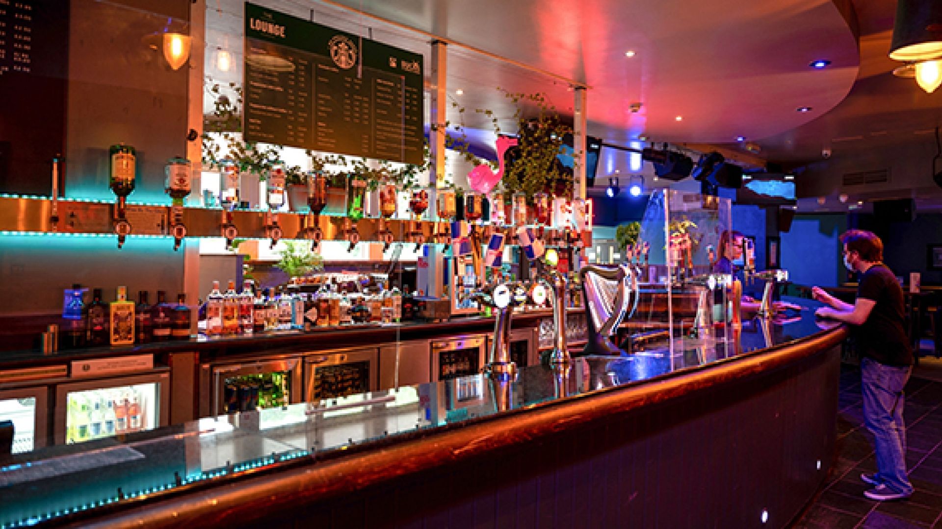 Students' Union bar with a student talking to the bar staff