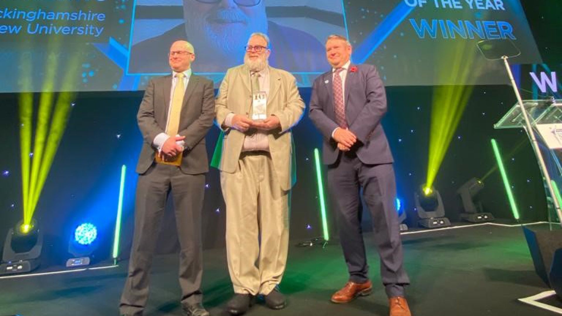 David Rawcliffe accepts Educator of the Year award on stage