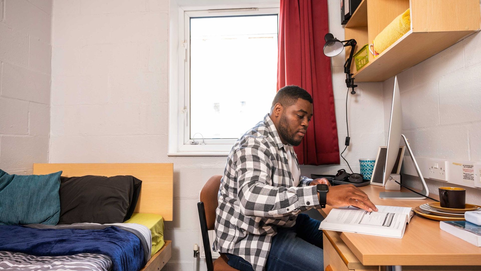 A student working at his desk in a Brook Street bedroom