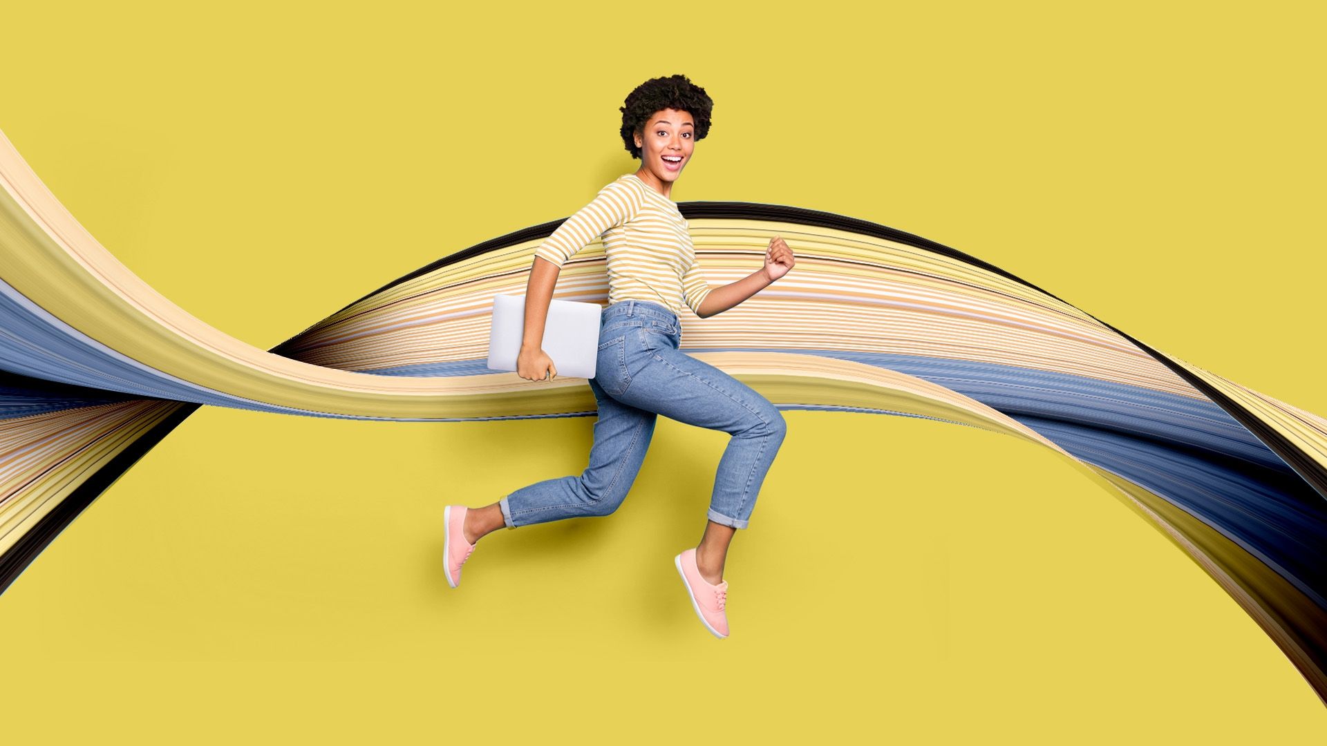 A student jumping in front of a yellow background with a swirl pattern behind