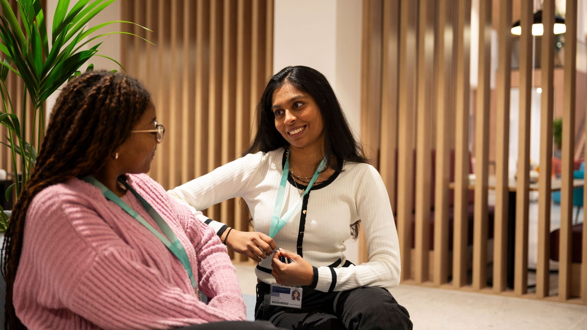 Two students chatting in the Atrium