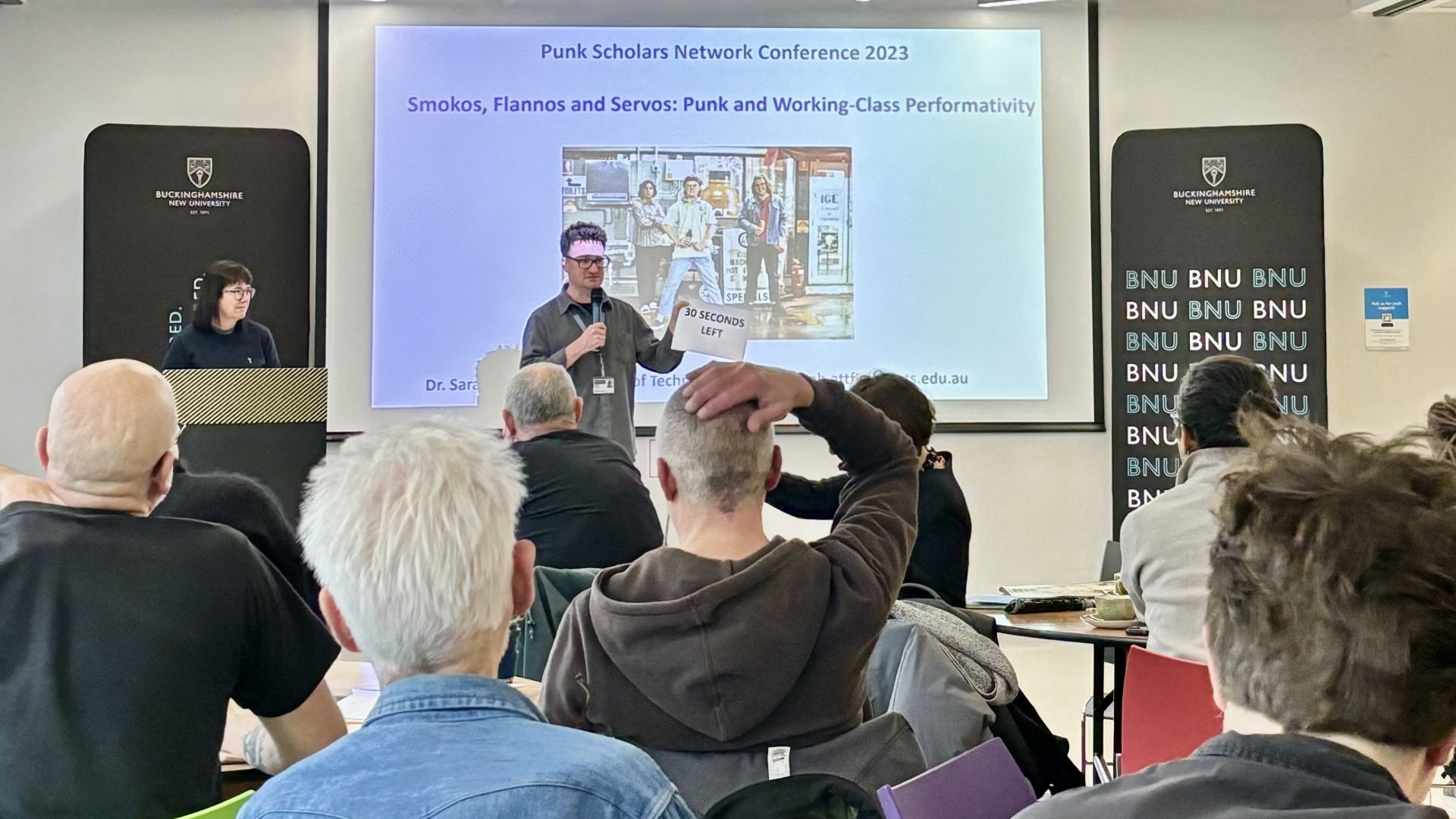 Paul Fields delivers presentation to attendees at Punk Scholars conference 
