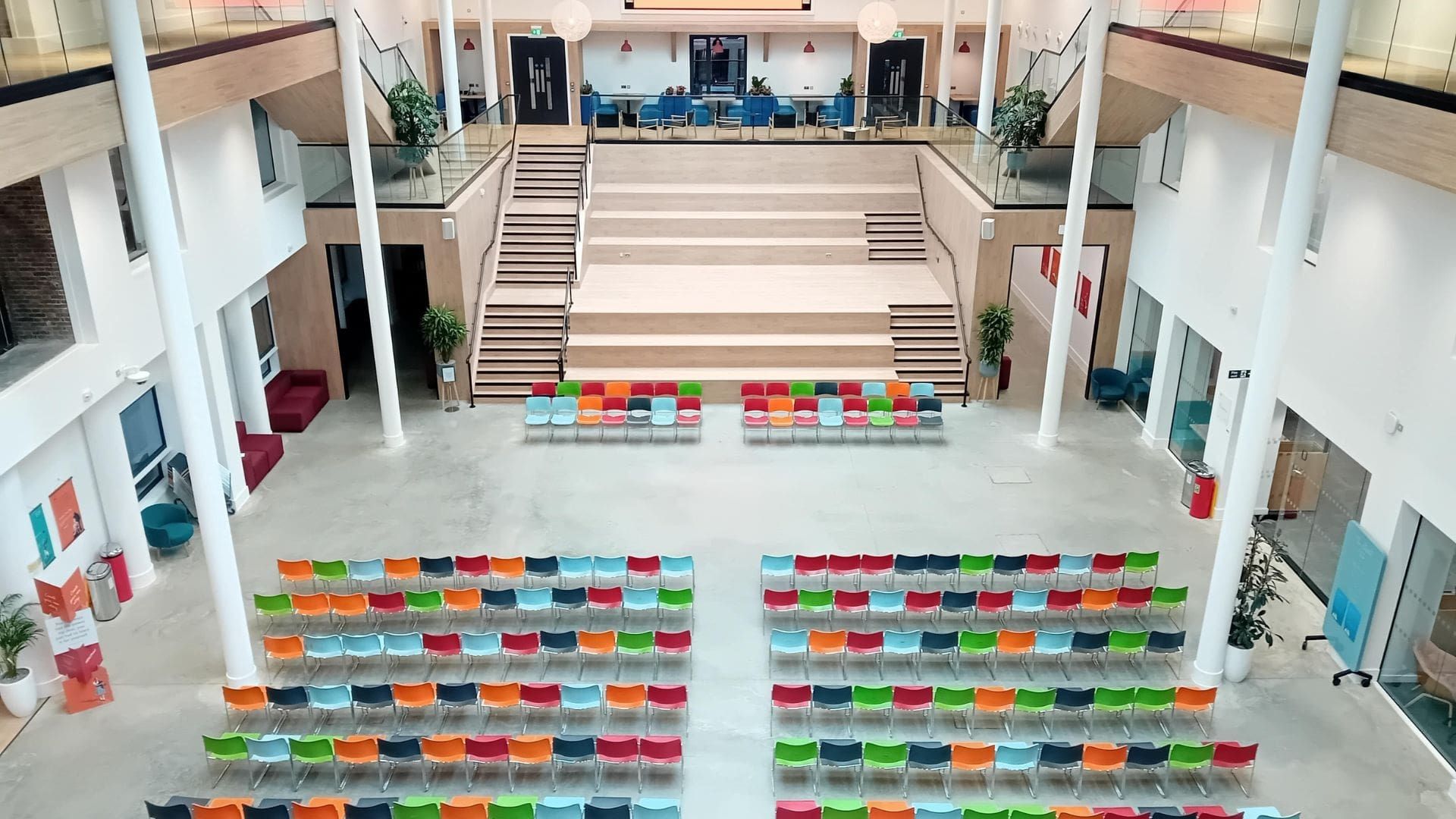 The Atrium from the top level, looking down on chairs lined up.