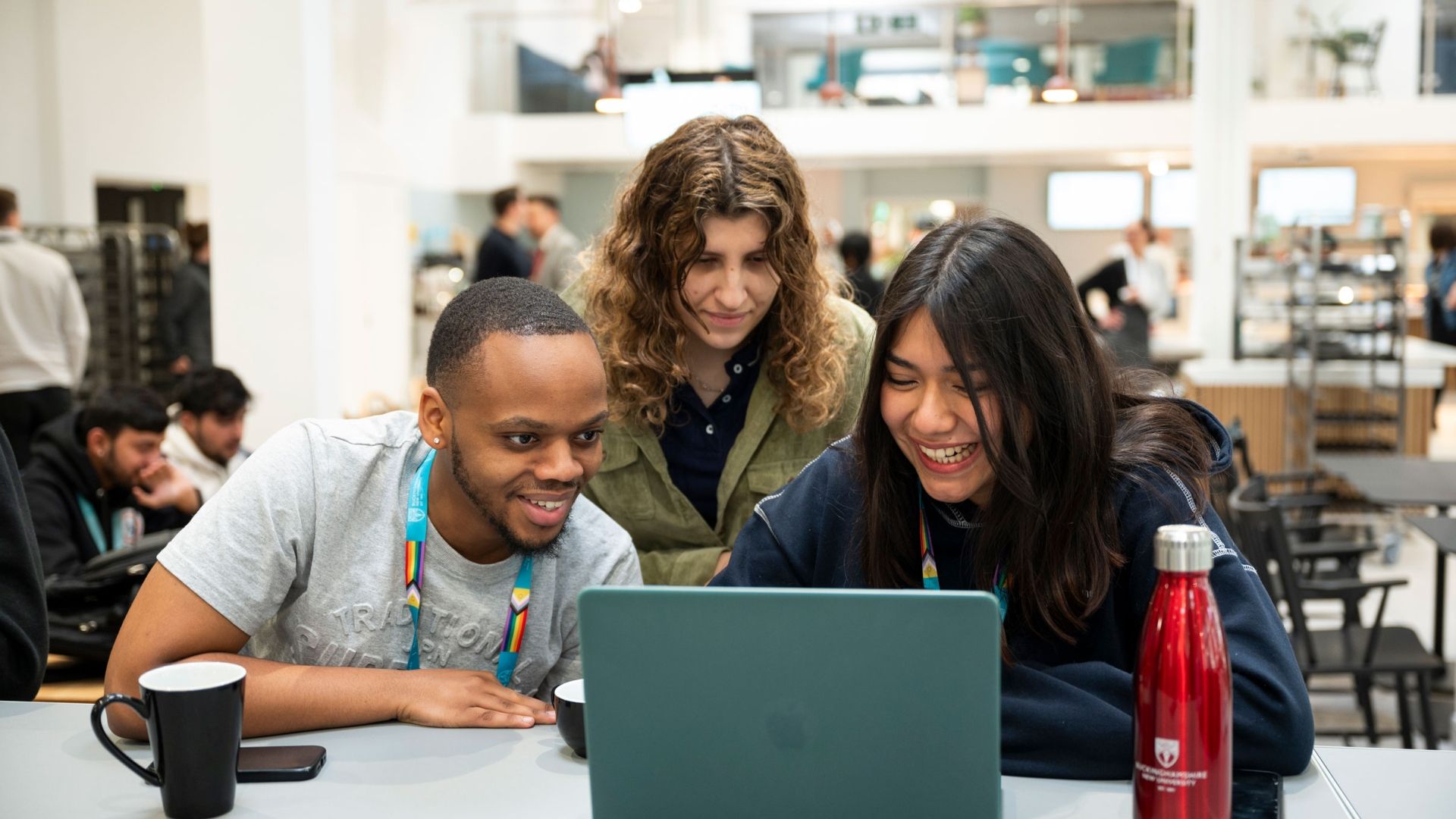Students gathered together around a laptop
