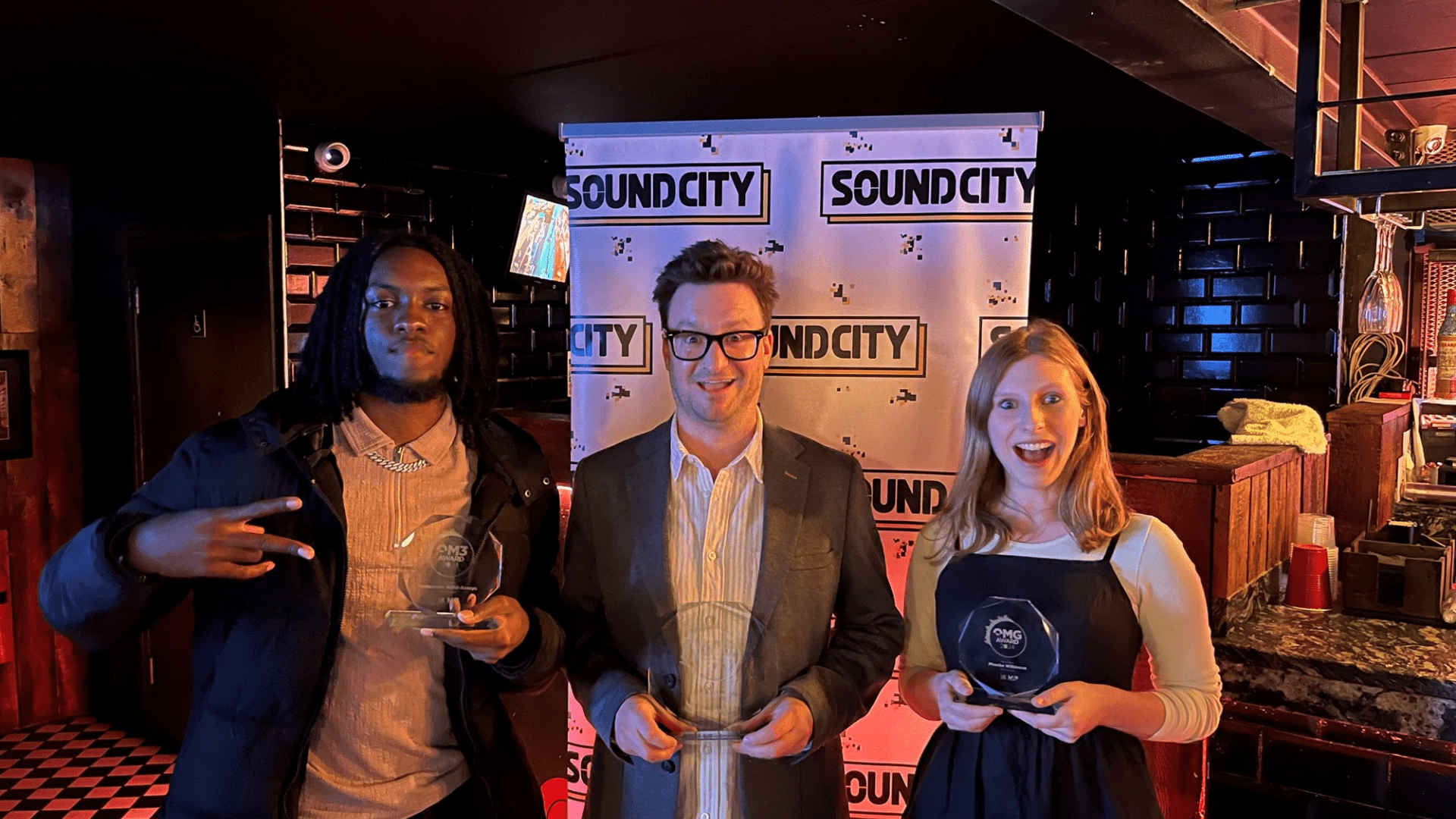 Emmanuel Alabi-Araoye, Paul Fields and Phoebe Wilkinson hold their trophies