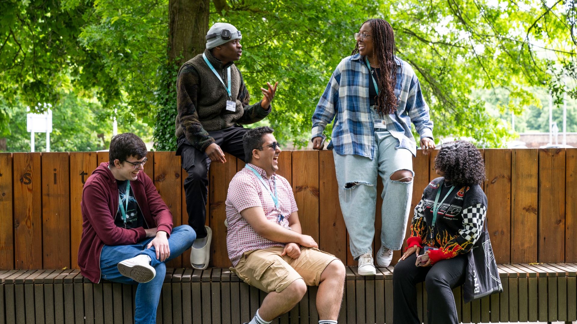 Five students sitting on a bench at High Wycombe campus