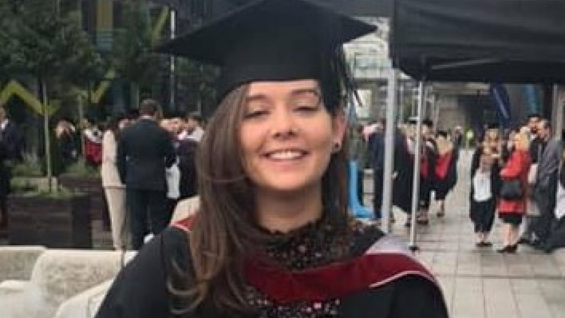 katie Pusey, Sports Therapy graduate in graduation gown and hat.