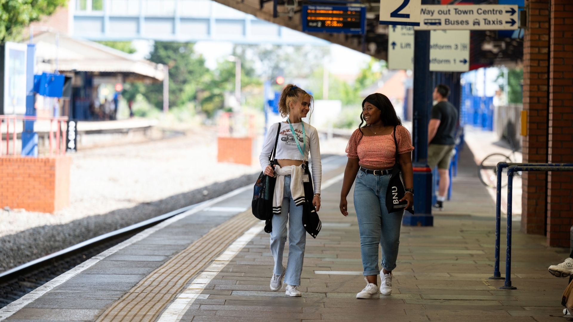 Two students walking in the train station