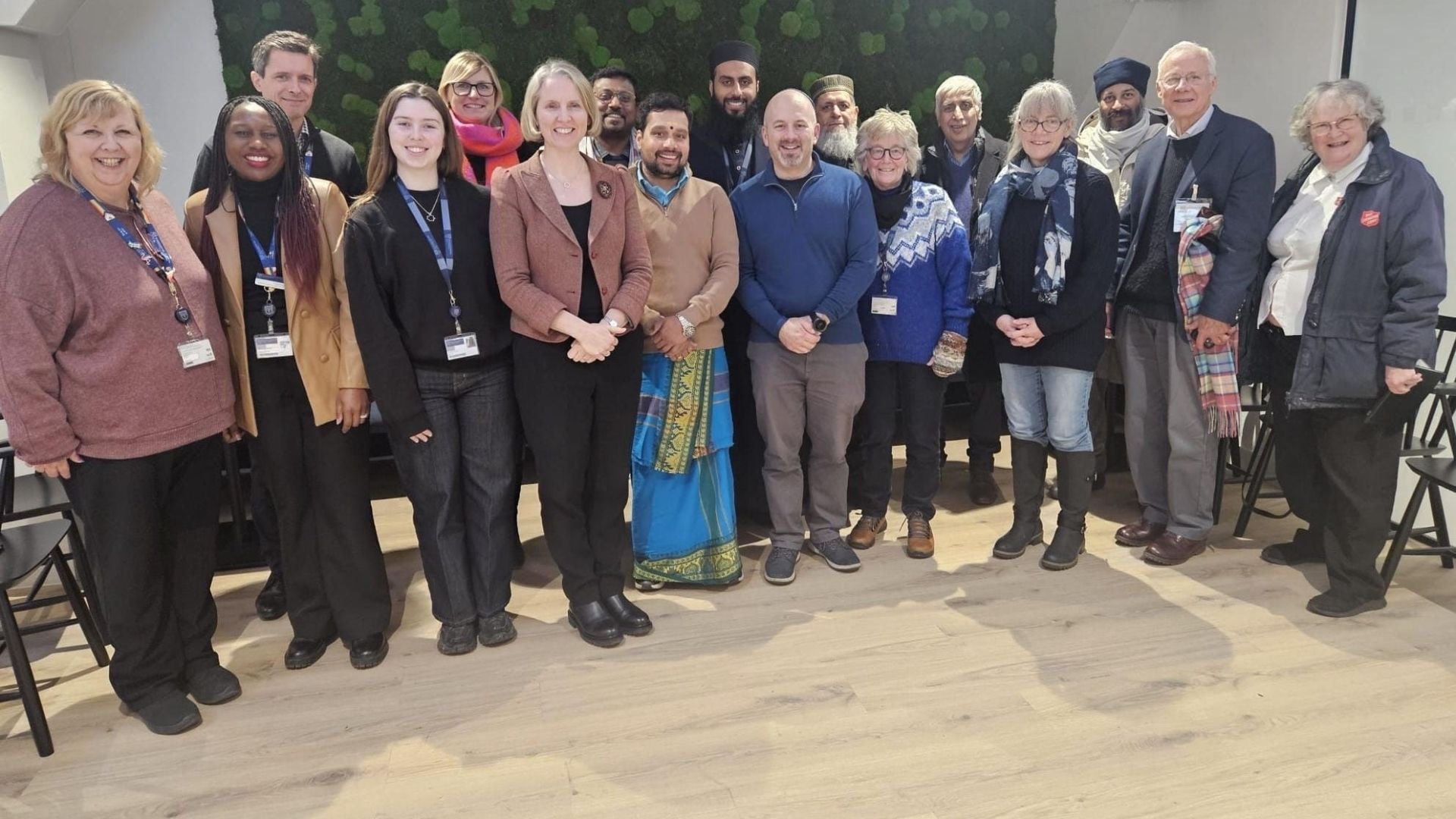 A large group of individuals standing together and smiling for a photo