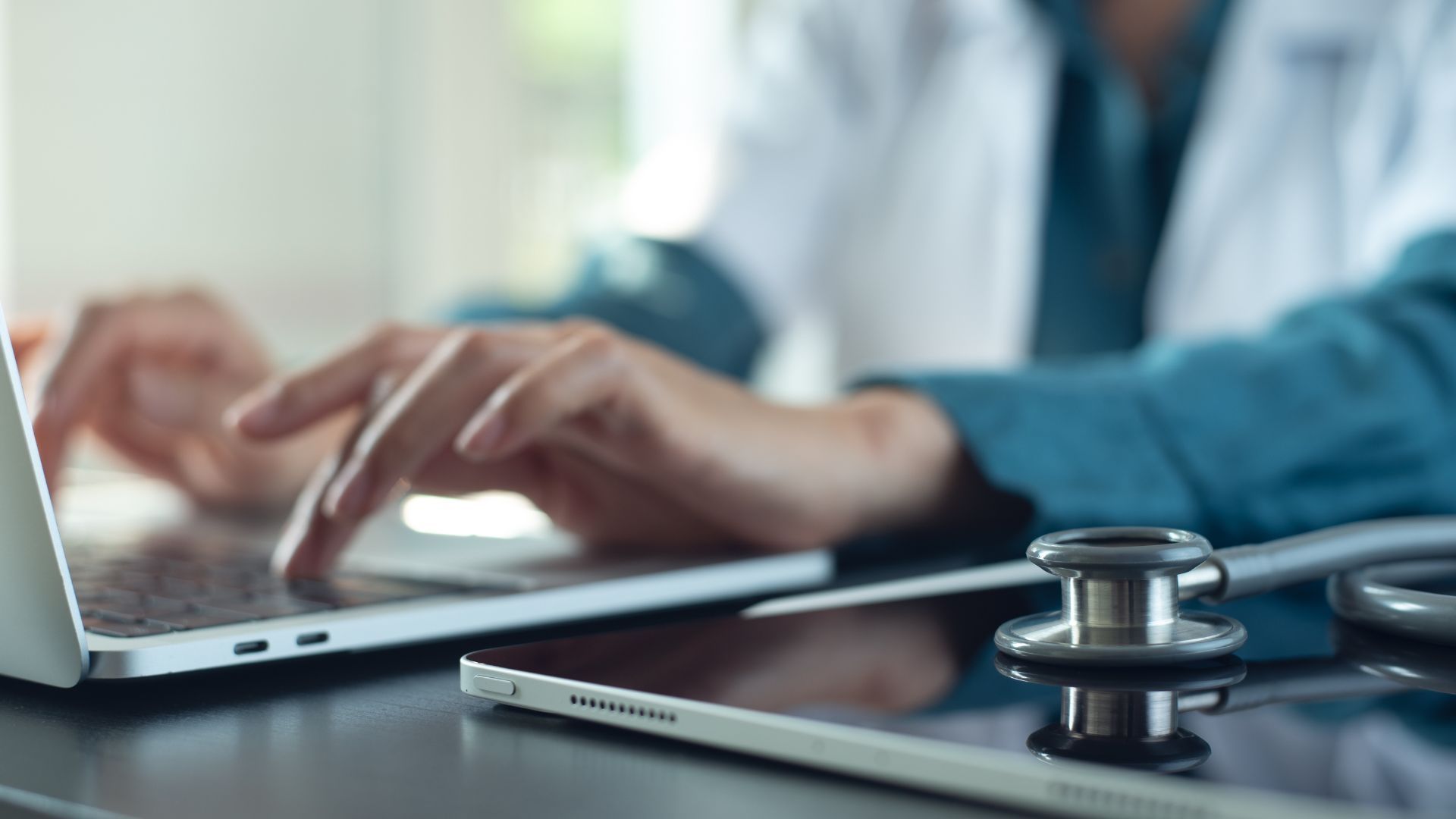 Nursing student typing on a laptop.