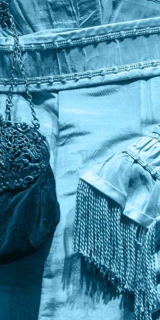 A close up of the midline of a blue victorian style dress 