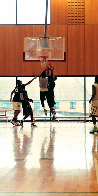 Men playing basketball in the sports hall