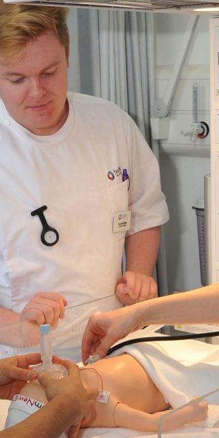 Three Bucks student nurses using a stethoscope on a child mannequin