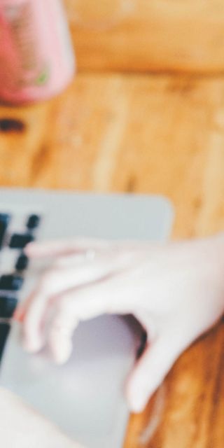 Female student typing on laptop studying