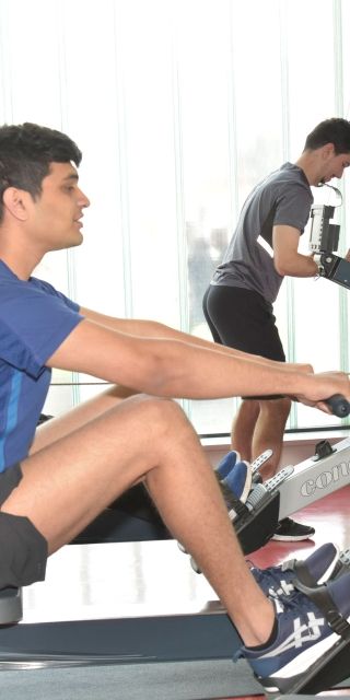 Gateway gym males on rowing machine 