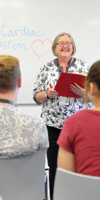 Nursing lecturer teaching a group of students