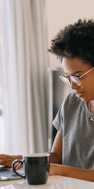 Young female student on a laptop at desk