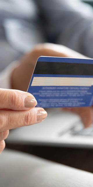 student holding a bank card