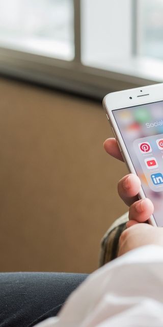 Person on Iphone with social media page open