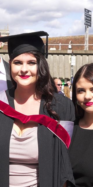 student graduation with parents/carers