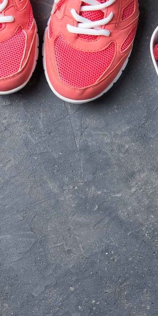 Living well image with weights fruit water and trainers