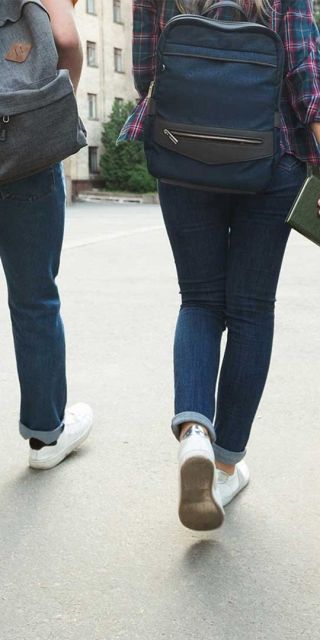 Six students all walking in a horizontal line together