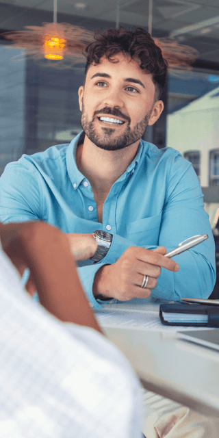 An accounting student in a meeting with another student whilst looking at data on a laptop