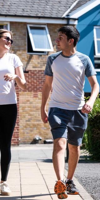 Two students walking together outside Brook Street accommodation
