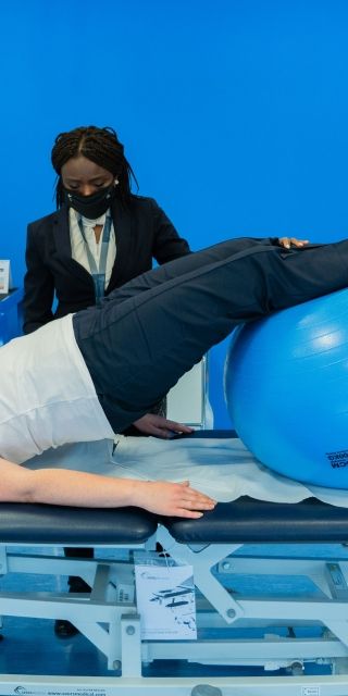 man and woman exercising in physiotherapy