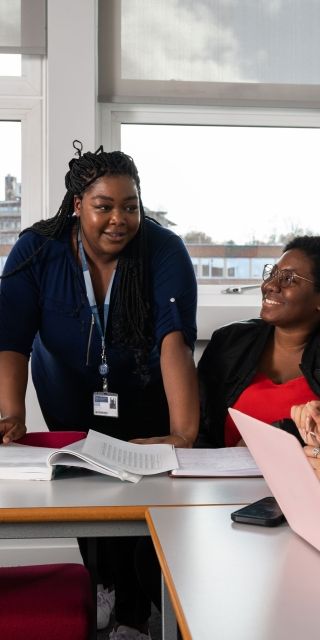 Lecturer talking to students in classroom