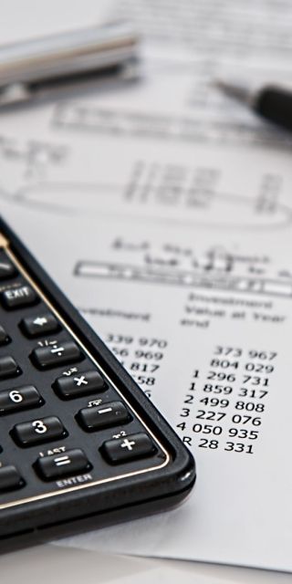 Calculator, pen and bill