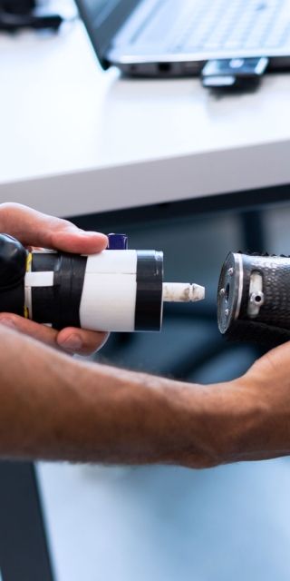 An amputee having a prosthetic hand attached to their arm.