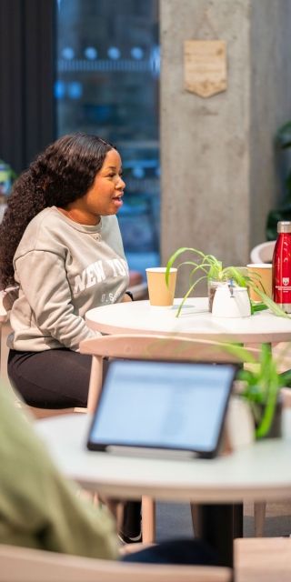 Two students sat together in the Garden Cafe