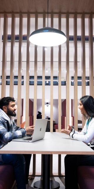 Students studying in a booth in the Atrium