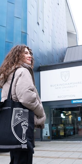 Female student outside gateway building on High Wycombe campus