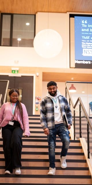Students walking around campus in the atrium