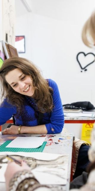 Fine art lecturer helping a student