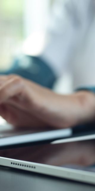 Nursing student typing on a laptop.