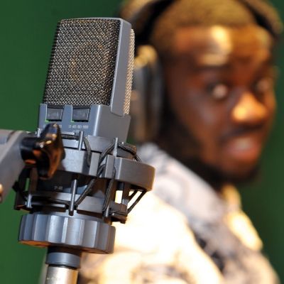 Bucks music student standing next to a vocal recording microphone