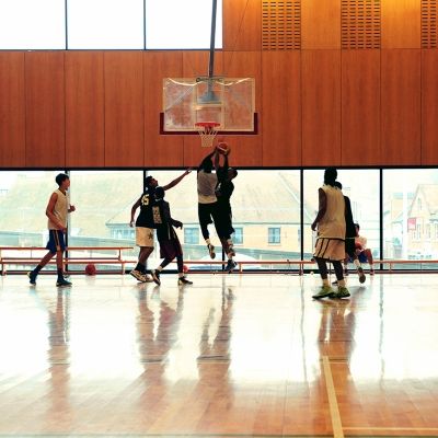 Men playing basketball in the sports hall