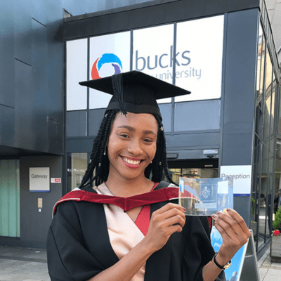 Dana Okeke on graduation day stood outside the gateway buliding