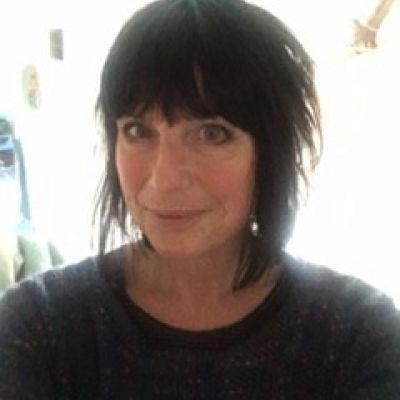 A head and shoulders shot of a smiling Jo Edwards wearing a dark grey jumper