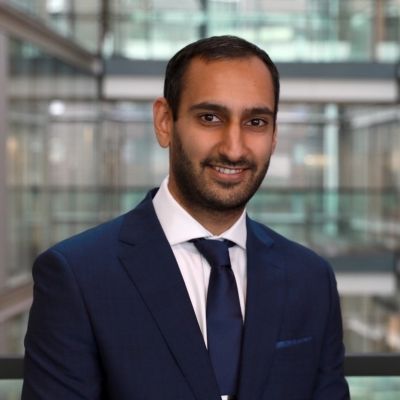 A head shot of Suraj in a blue suit